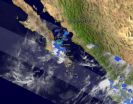 GOES-13s wide view of Atlantics Tropical Storm Lisa and low, Pacifics Georgette