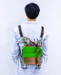 Load-reducing backpack powers electronics by harvesting energy from walking