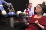 Paralyzed individuals use thought-controlled robotic arm to reach and grasp