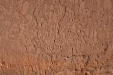 Stone age artists carved detailed human and animal tracks in rock art in Namibia